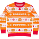 Illustration for article titled Because #TheChickening Knows No Bounds, Popeyes’ Chicken Sandwich Jumps the Shark—Onto an Ugly Christmas Sweater